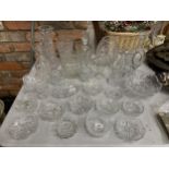 A QUANTITY OF CUT GLASS ITEMS TO INCLUDE, DECANTERS, VASES, JUGS, BOWLS, ETC
