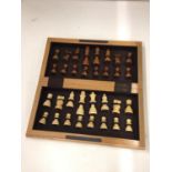 A WOODEN CHESS BOARD WITH WOODEN CHESS PIECES SIZE 27CM X 29CM