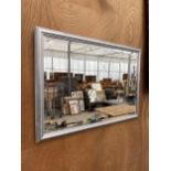 A WOODEN FRAMED SILVER PAINTED BEVELED EDGE WALL MIRROR