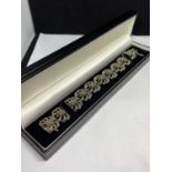 A DECORATIVE SILVER AND MARCASITE BRACELET IN A FLOWER DESIGN WITH A PRESENTATION BOX