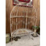 A DECORATIVE WROUGHT IRON GARDEN SEAT WITH ARCHED BACK AND TOP