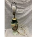 A DECORATIVE VINTAGE LAMP IN PALE AND DARK GREEN WITH AN IMAGE OF A COUPLE. HEIGHT TO THE TOP OF THE