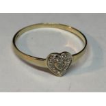 A 9 CARAT GOLD RING WITH A HEART SHAPE MADE UP OF DIAMONDS SIZE S