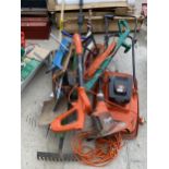AN ASSORTMENT OF GARDEN TOOLS TO INCLUDE A FLYMO, GRASS STRIMMERS AND SPADES ETC