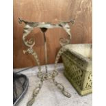 A DECORATIVE WROUGHT IRON PLANT STAND WITH LION PAW FEET