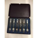 A BOXED SET OF SIX PLATED CAKE FORKS WITH DECORATIVE CERAMIC HANDLES