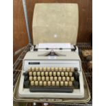 A RETRO ADLER TYPE WRITER WITH CARRY CASE