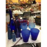 A COLLECTION OF BLUE GLASS ITEMS TO INCLUDE BEAKERS, BOTTLES, GOBLETS, ETC