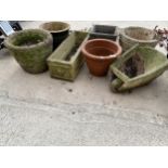 A LARGE ASSORTMENT OF GARDEN PLANTERS TO INCLUDE A RECONSTITUTED STONE WHEEL BARROW, A TERRACOTTA