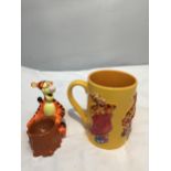 TWO DISNEY CERAMIC ITEMS TO INCLUDE A TIGGER MUG AND A TIGGER FIGURE