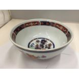 AN ORIENTAL BOWL WITH BLUE, ORANGE AND GOLD PATTERN