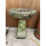 A RECONSTITUTED STONE BIRD BATH WITH PEDESTAL BASE