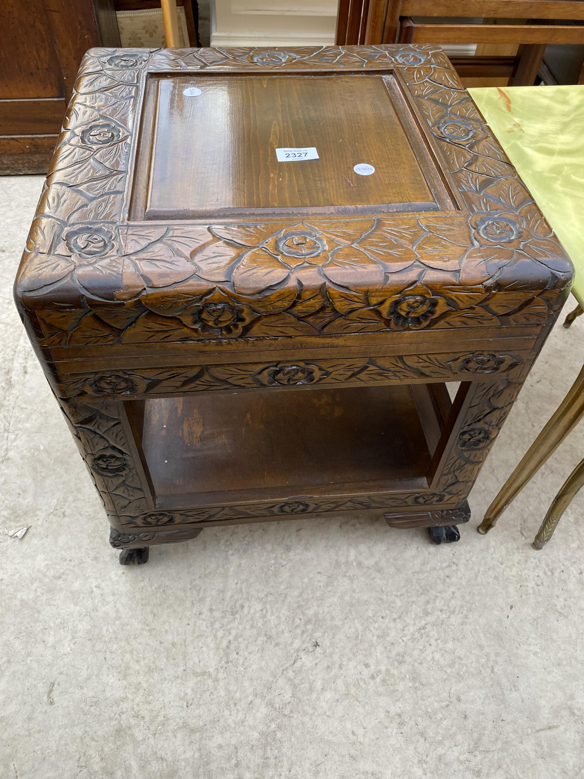A HEAVILY CARVED ORIENTAL LAMP TABLE