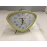 A RETRO YELLOW ALARM CLOCK