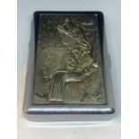 A WHITE METAL CIGARETTE CASE WITH A NORTH AMERICAN INDIAN AND WOLF DESIGN