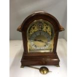 A GEORGE III STYLE OAK CASED BRACKET CLOCK WITH DOMED TOP REEDED COLUMNS EMBOSSED BRASS FACE AND