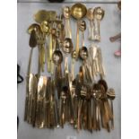 A LARGE AMOUNT OF YELLOW METAL CUTLERY TO INCLUDE KNIVES, FORKS, SPOONS, ETC