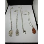 FOUR MARKED SILVER NECKLACES WITH PENDANTS TO INCLUDE A LEAF, DOLPHIN, ONYX STYLE STONE AND A