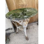 A DECORATIVE CAST IRON PATIO TABLE WITH STONE TOP