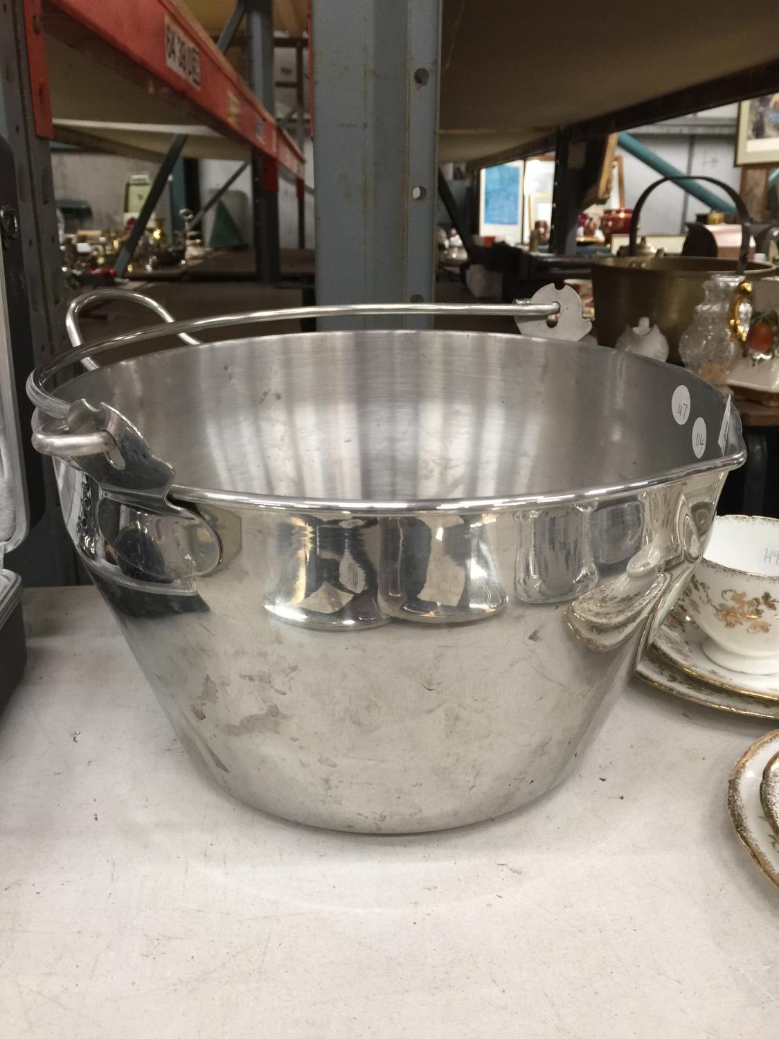 A LARGE STAINLESS STEEL COOKING POT