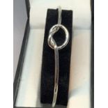 A MARKED SILVER BANGLE WITH A TWIST DESIGN IN A PRESENTATION BOX