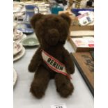 A VINTAGE- POSSIBLY STEIFF - BERLIN BROWN BEAR WITH A BERLIN SASH. HEIGHT 26CM
