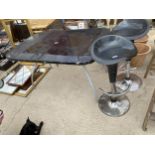 TWO PUMP ACTION KITCHEN STOOLS AND A GLASS TAPPED GARDEN TABLE