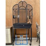 A LARGE PET CAGE WITH WHEELED TROLLEY BASE TO INCLUDE VARIOUS ACCESORIES