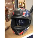 A BLACK, RED, AND BLUE AGV MOTORBIKE HELMET