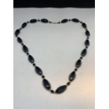 A 14 CARAT GOLD AND ONYX NECKLACE