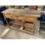 A VINTAGE PINE WORK STATION ENCLOSING TWO DRAWRS AND A LOWER SHELF