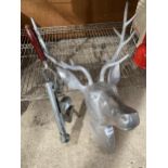A DECORATIVE METAL STAGS HEAD AND A VINTAGE BOTTLE OPENER