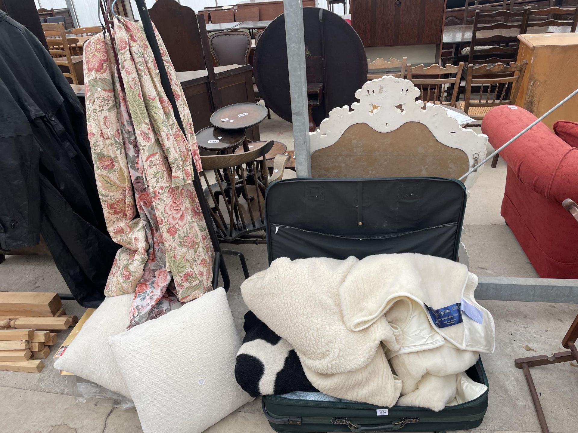 A SUITCASE CONTAINING AN ASSORTMENT OF THROWS, CUSHIONS AND CURTAINS
