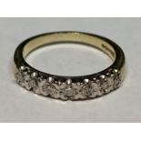 A 9 CARAT GOLD RING WITH SEVEN IN LINE DIAMONDS SIZE L/M