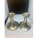 TWO HALLMARKED BIRMINGHAM SILVER CANDLESTICKS ONE WEIGHTED WITH INDISTINCT HALLMARK AND ONE