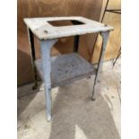 A VINTAGE CAST STOOL WITH LOWER SHELF