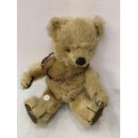 A VINTAGE JOINTED TEDDY BEAR WITH AN INNER 'SQUEAK'