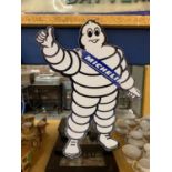 A METAL MICHELIN MAN SIGN