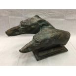 A BRONZE EFFECT STONE BUST OF TWO GREYHOUND HEADS LENGTH 48CM HEIGHT 29CM