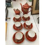 AN ORIENTAL STYLE TEASET WITH A RED DRAGON DESIGN AND THE IMAGE OF A JAPANESE LADY IN THE CUP TO