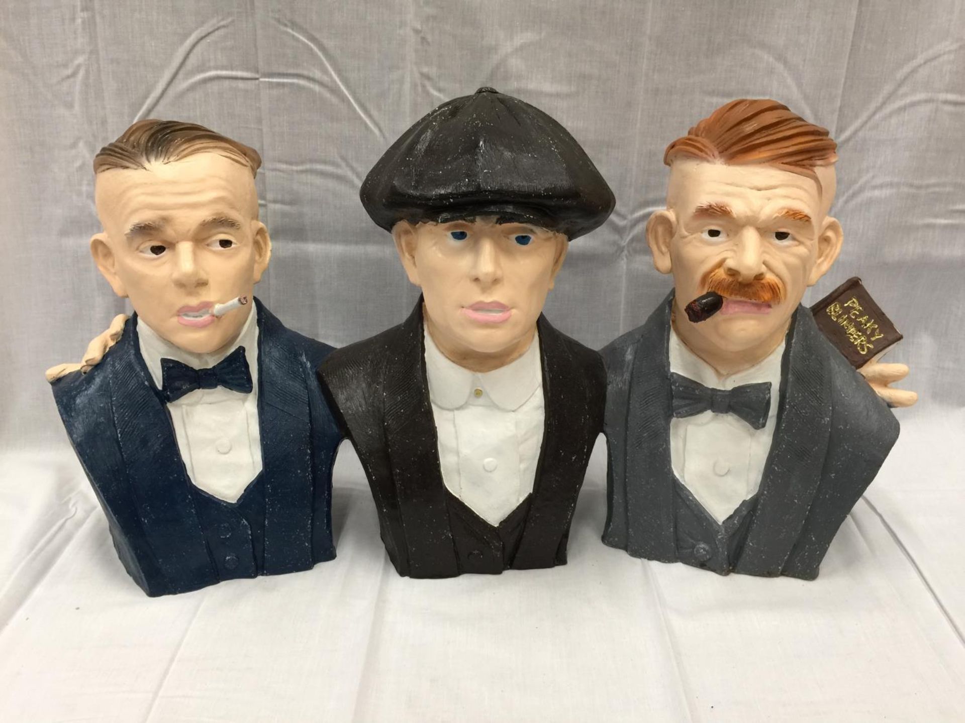 A LARGE PEAKY BLINDERS BUST OF THE THREE SHELBY BROTHERS APPROXIMATELY 80CM X 40CM