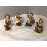 FOUR WEST GERMAN HUMMEL FIGURINES - LITTLE GOAT HERDER, HAPPY TRAVELLER, BOY READING NEWSPAPER AND