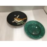 TWO COLLECTABLE PLATES, ONE A GREEN WEDGWOOD CABBAGE LEAF PLUS A STUDIO POTTERY PLATE WITH A BIRD