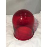 A RED GLASS CLOCHE HEIGHT 23CM DIAMETER 20CM (CHIP TO BASE)