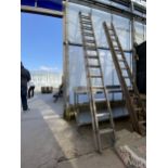 A TWO SECTION ALUMINIUM EXTENDING LADDER (13 RUNGS PER SECTION)