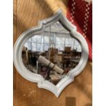 A DECORATIVE WOODEN FRAMED WALL MIRROR