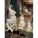 A SET OF THREE WHITE CERAMIC HANGING CLOWNS