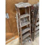 A VINTAGE FIVE RUNG WOODEN STEP LADDER AND A VINTAGE THREE RUNG WOODEN STEP LADDER