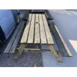 A VINTAGE WOODEN SLATTED GARDEN PICNIC BENCH