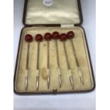 A BOXED SET OF SIX HALLMARKED BIRMINGHAM SILVER COCKTAIL STICKS WITH RED BEADS